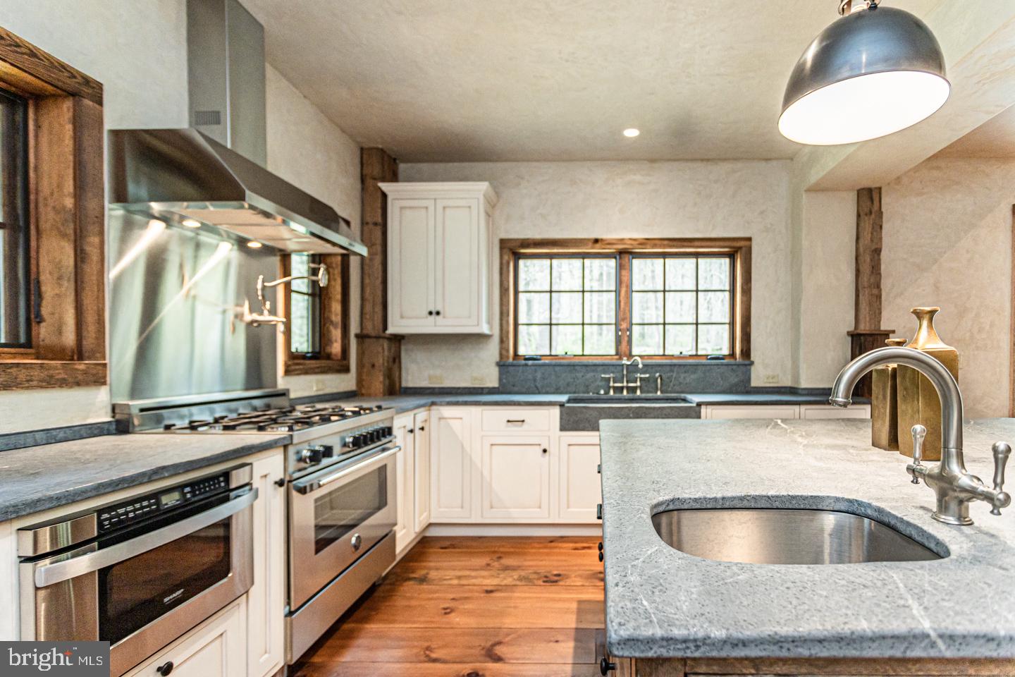 340 Thompson Mill Road New Hope, PA 18938 - Photo 20 of 76 a kitchen with granite countertop a stove and a sink