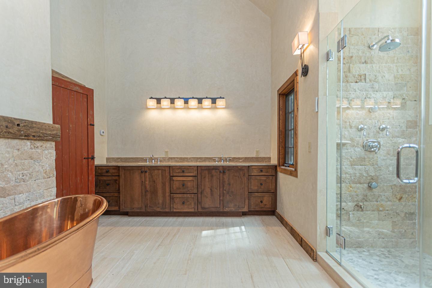 340 Thompson Mill Road New Hope, PA 18938 - Photo 29 of 76 a bathroom with a tub a sink and glass door