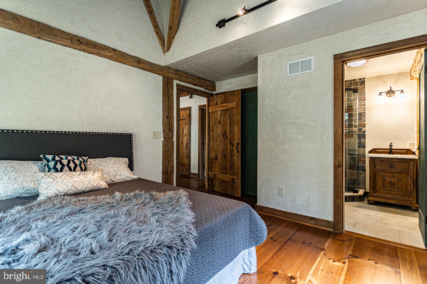 340 Thompson Mill Road New Hope, PA 18938 - Photo 45 of 76 a bedroom with a bed and wooden floor