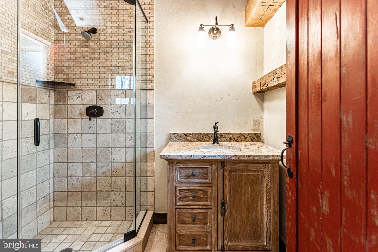 340 Thompson Mill Road New Hope, PA 18938 - Photo 50 of 76 a bathroom with a granite countertop sink a mirror and shower