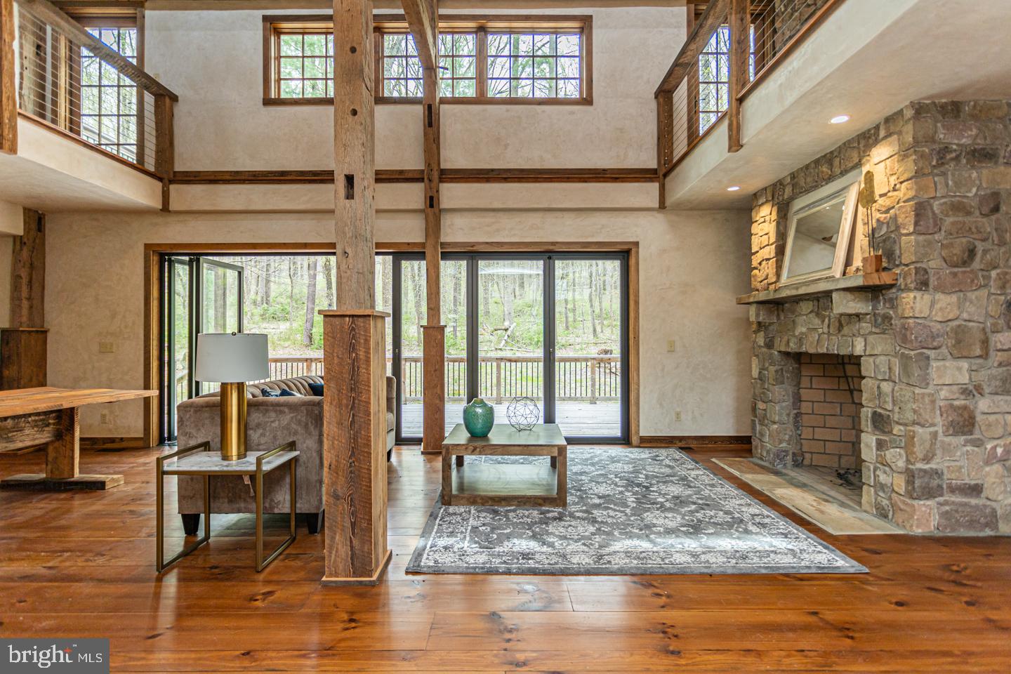 340 Thompson Mill Road New Hope, PA 18938 - Photo 10 of 76 a living room with fireplace furniture and a floor to ceiling window