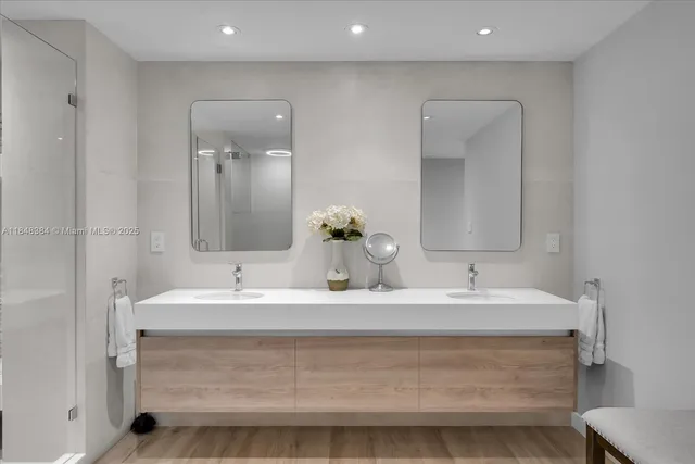 a bathroom with a sink double vanity and a mirror