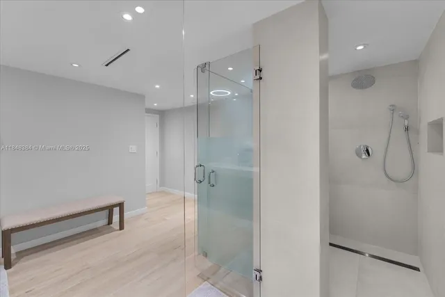 a bathroom with a shower and a glass door