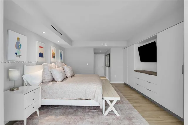 a bedroom with a bed and a flat screen tv