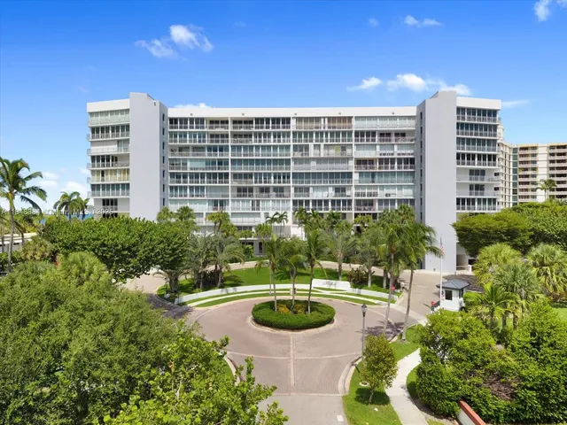 a view of a swimming pool with lawn chairs and plants