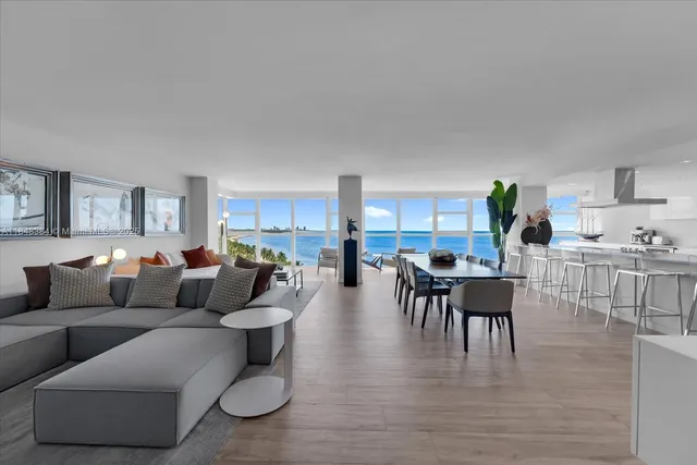 a living room with furniture and view of kitchen