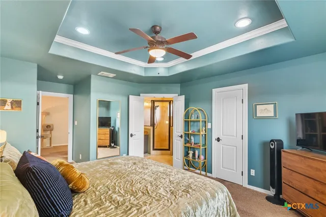 a bedroom with a bed and a large mirror with a flat tv screen