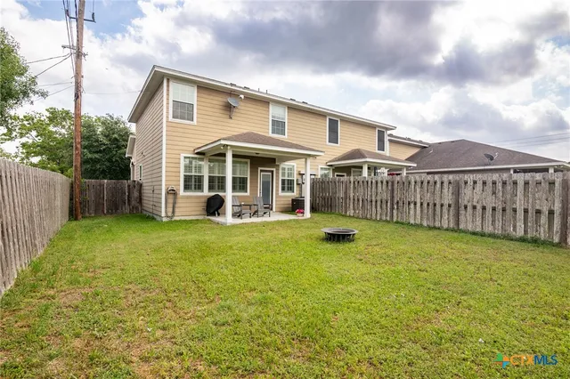 a view of a house with a yard and sitting area