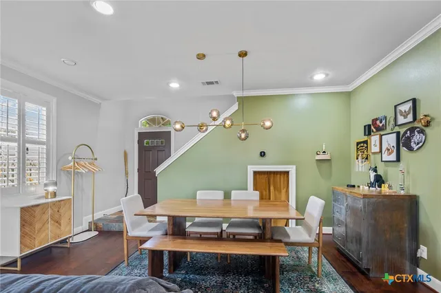 a living room with furniture a table and wooden floor