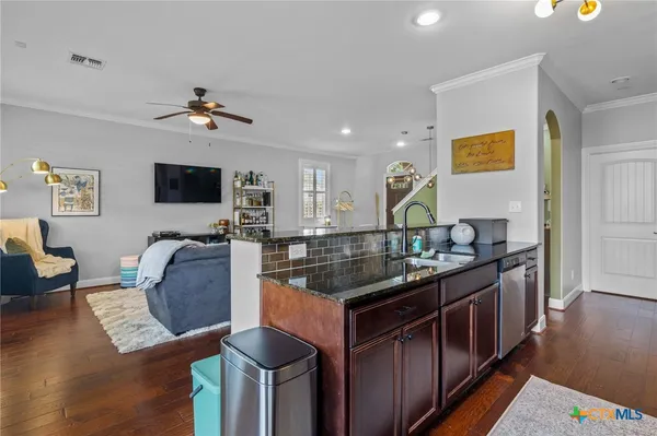 a kitchen with stainless steel appliances granite countertop a stove and a sink