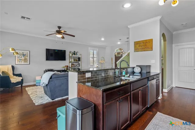 a kitchen with stainless steel appliances granite countertop a stove and a sink