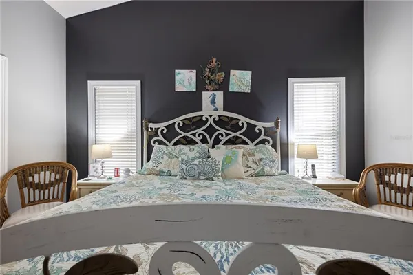 a roof deck with table and chairs and potted plants