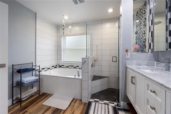 a view of a white house with a big yard and potted plants