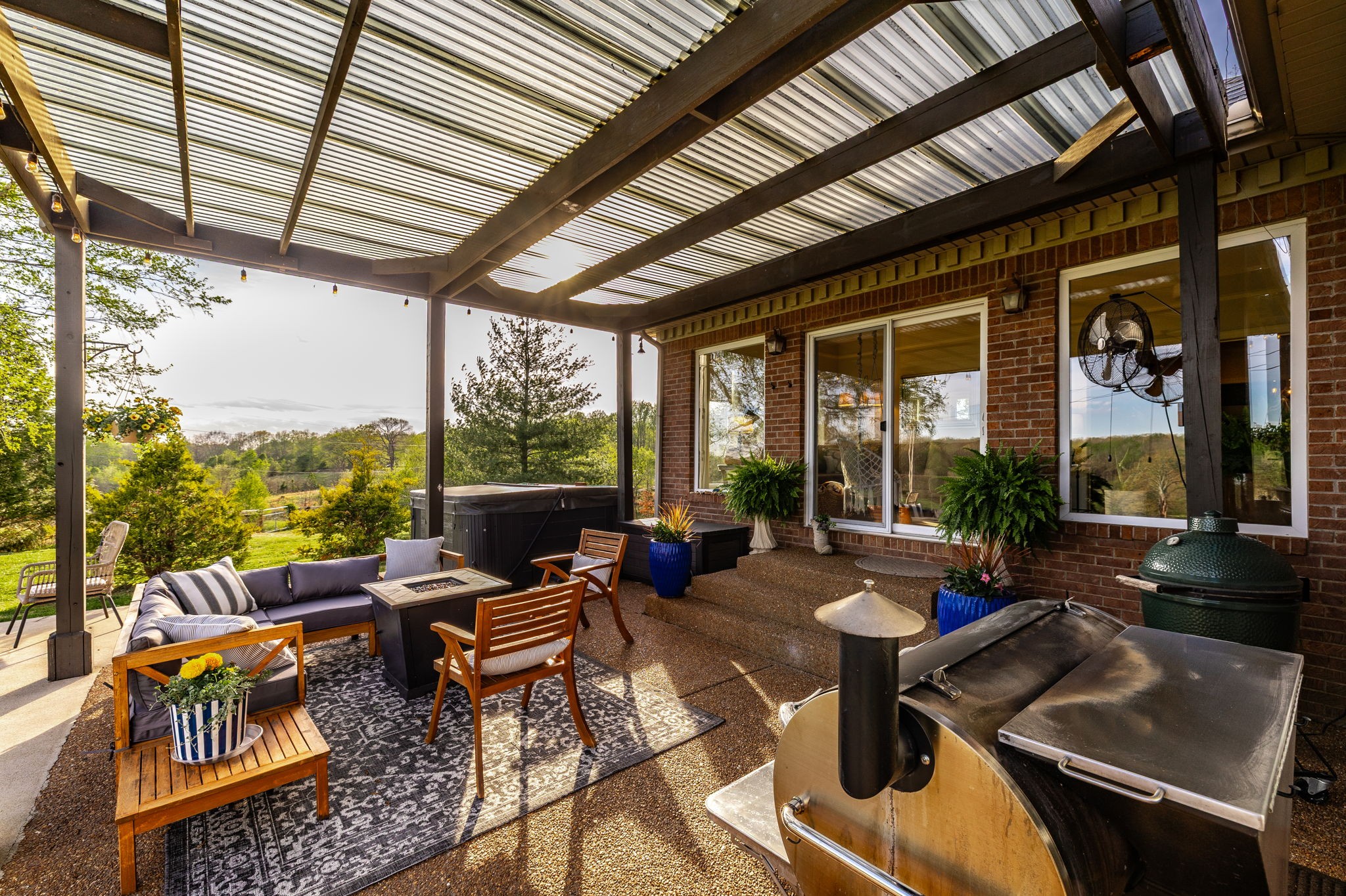 1075 Fannie Nicholson Road Chapmansboro, TN 37035 - Photo 22 of 100 a living room with patio furniture and a floor to ceiling window next to a yard