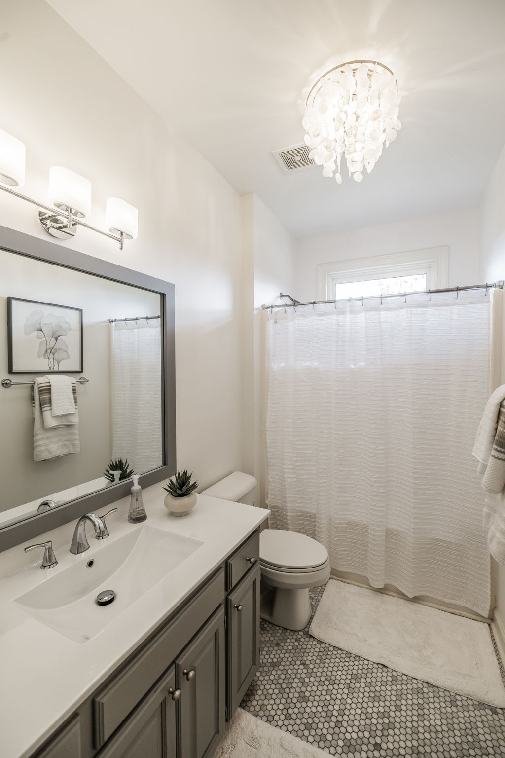 1075 Fannie Nicholson Road Chapmansboro, TN 37035 - Photo 84 of 100 a bathroom with a sink a toilet a mirror and shower