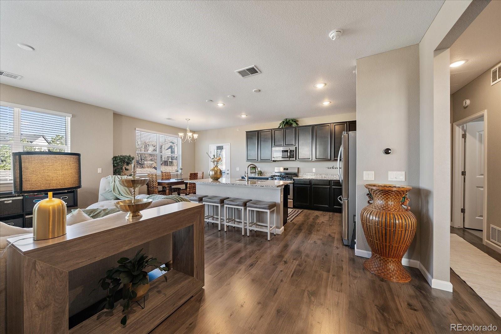 4474 Copeland Circle, Unit 203 Highlands Ranch, CO 80126 - Photo 1 of 33 a kitchen view with a dining table chairs and refrigerator