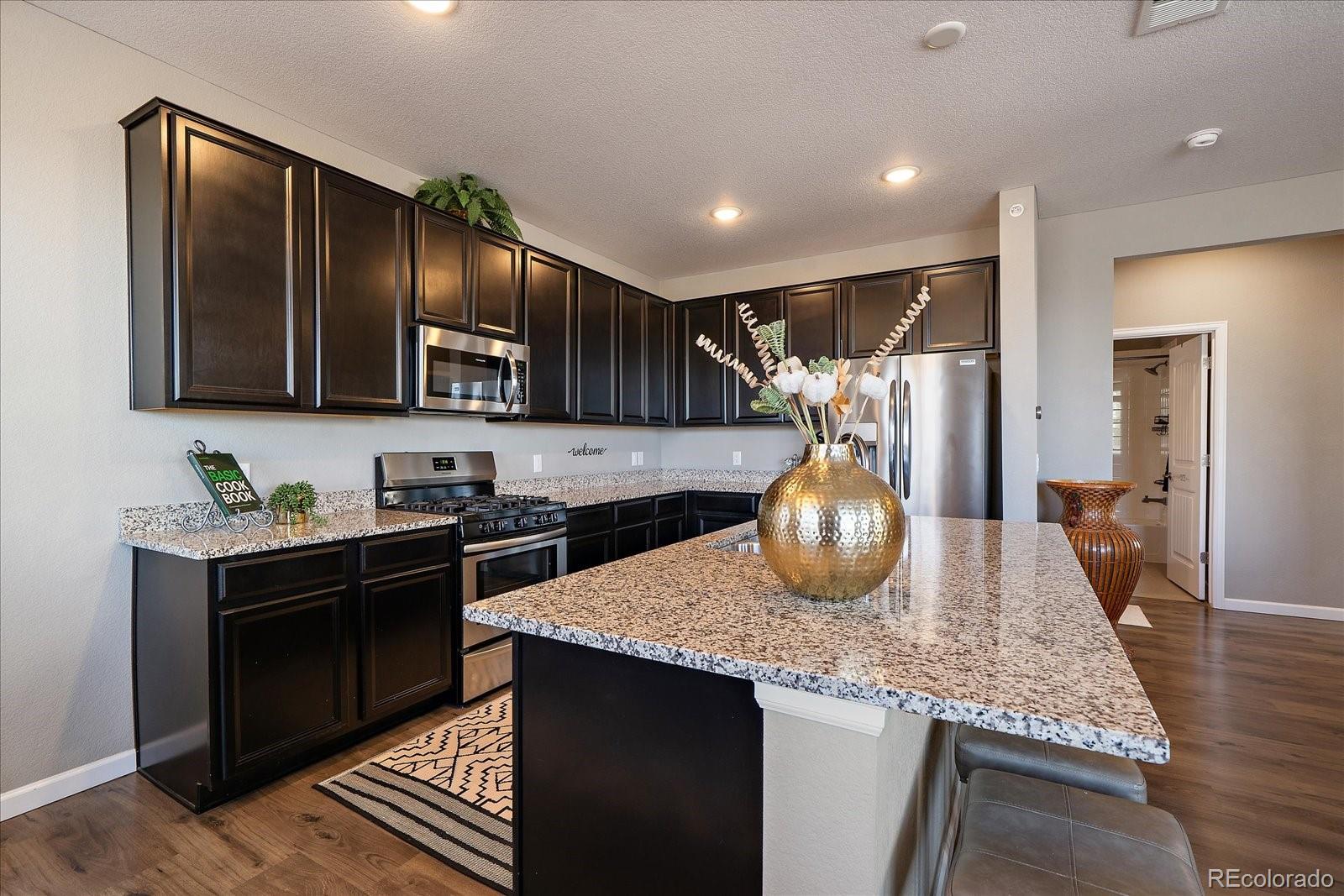 4474 Copeland Circle, Unit 203 Highlands Ranch, CO 80126 - Photo 11 of 33 a kitchen with sink cabinets and stove
