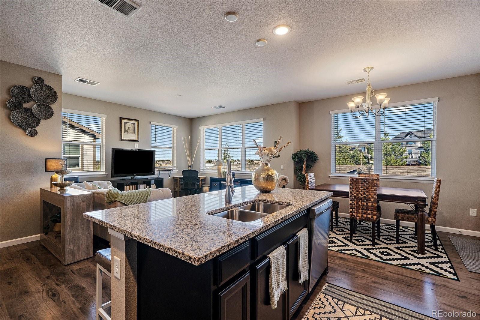 4474 Copeland Circle, Unit 203 Highlands Ranch, CO 80126 - Photo 13 of 33 a open kitchen with a table and chairs in it