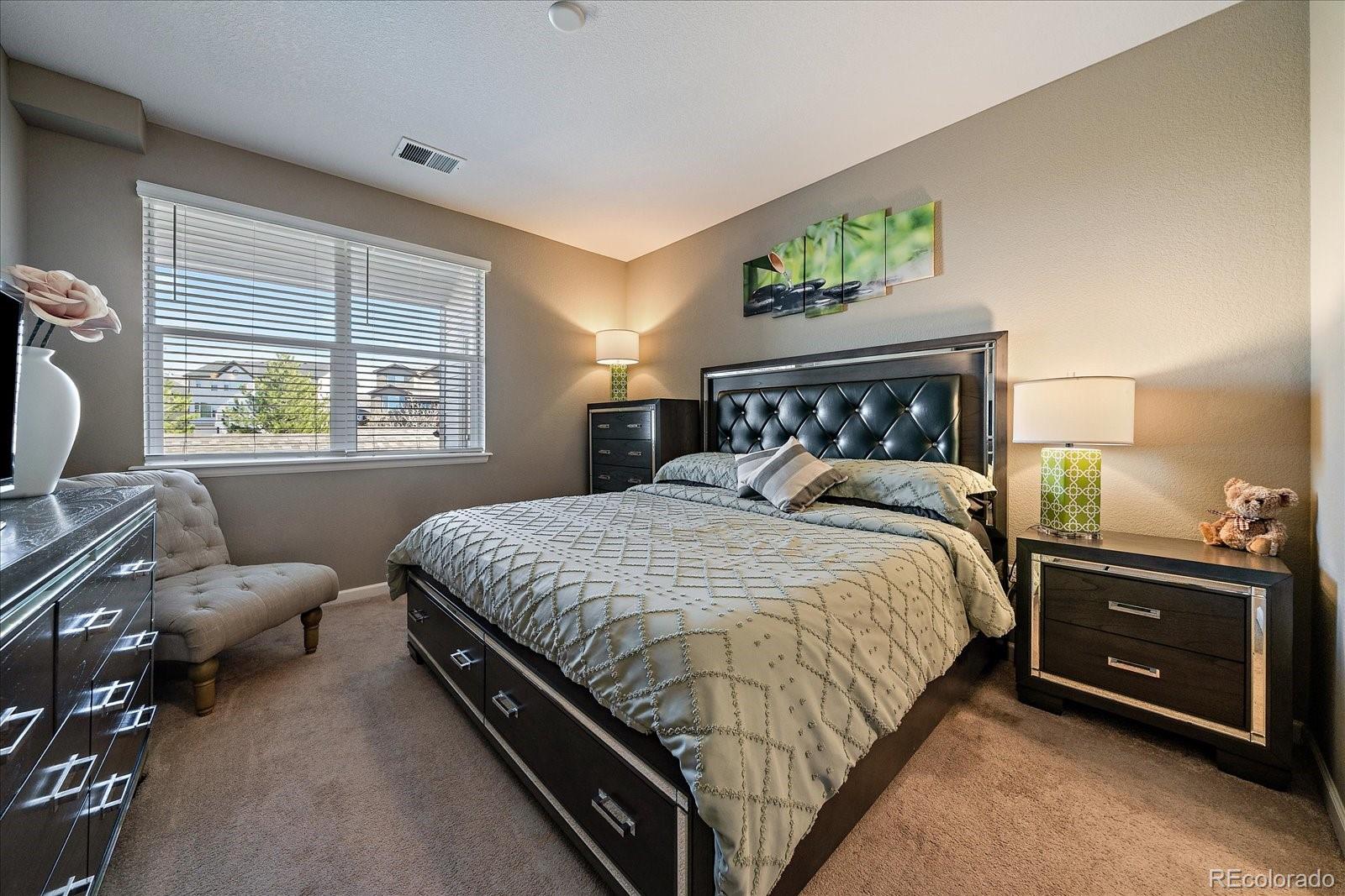 4474 Copeland Circle, Unit 203 Highlands Ranch, CO 80126 - Photo 14 of 33 a bed sitting in a bedroom next to a window