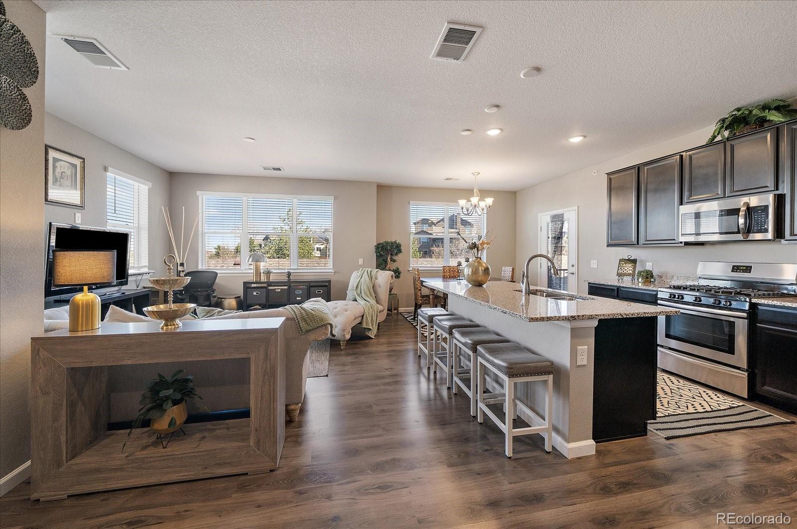 4474 Copeland Circle, Unit 203 Highlands Ranch, CO 80126 - Photo 5 of 33 a large white kitchen with lots of counter space a sink and appliances