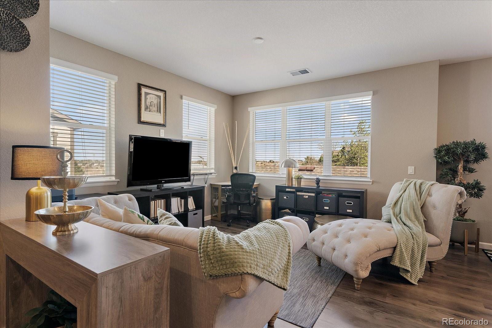 4474 Copeland Circle, Unit 203 Highlands Ranch, CO 80126 - Photo 6 of 33 a living room with furniture and a flat screen tv