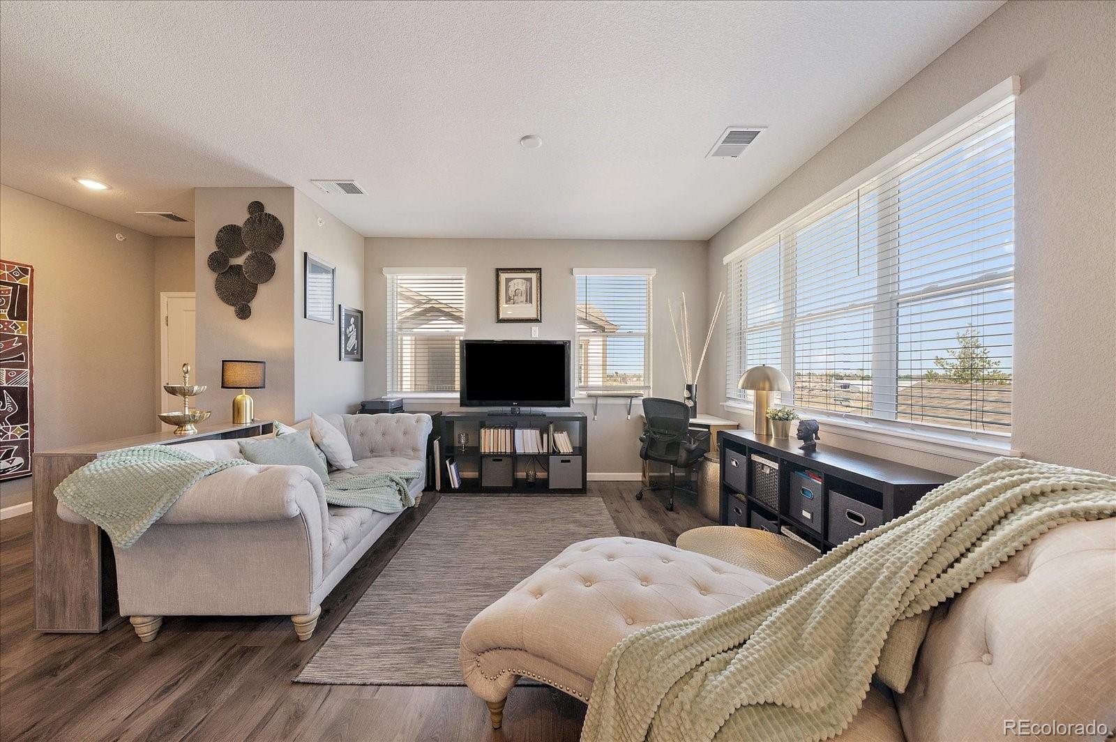 4474 Copeland Circle, Unit 203 Highlands Ranch, CO 80126 - Photo 7 of 33 a living room with furniture and a flat screen tv