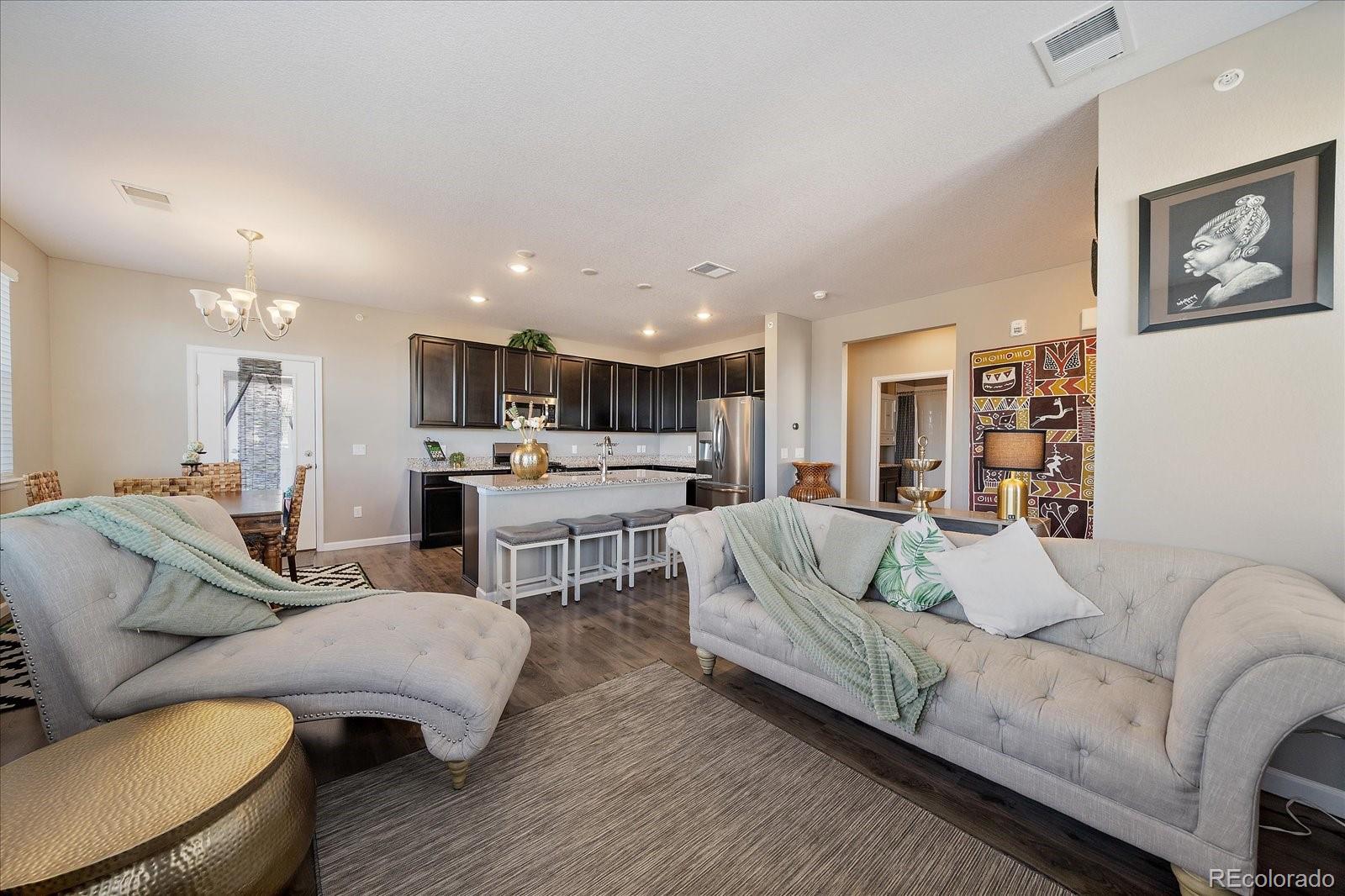 4474 Copeland Circle, Unit 203 Highlands Ranch, CO 80126 - Photo 8 of 33 a living room with furniture and kitchen view