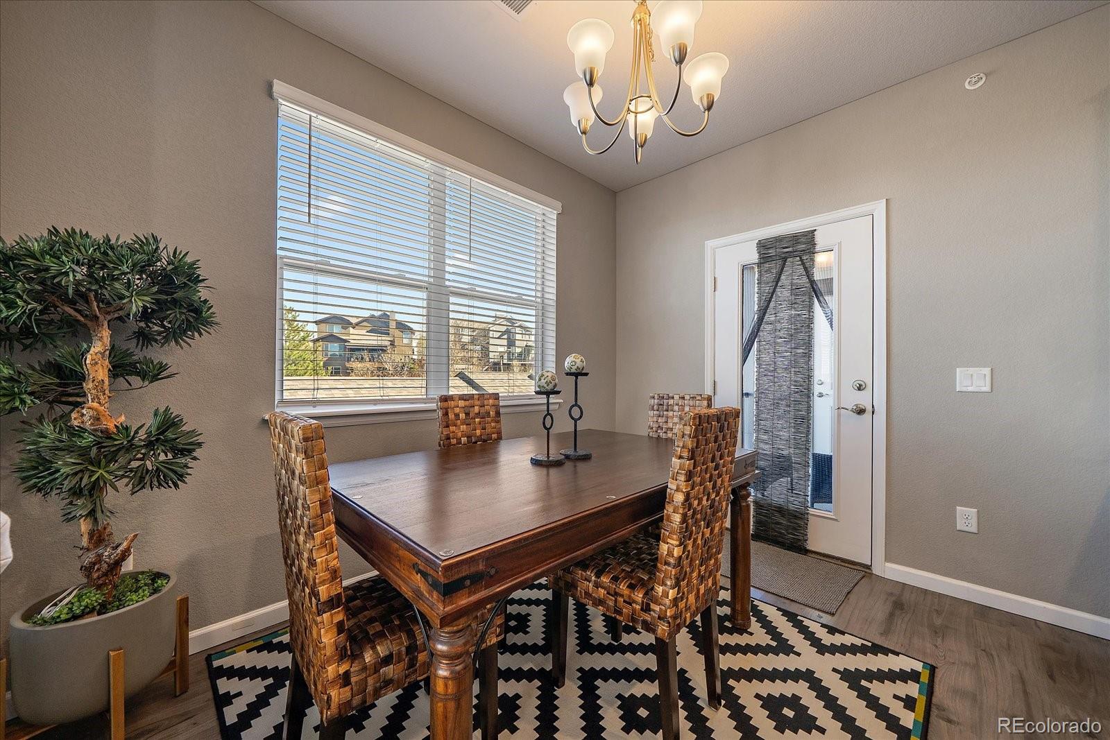 4474 Copeland Circle, Unit 203 Highlands Ranch, CO 80126 - Photo 10 of 33 a view of a dining room with furniture window and wooden floor