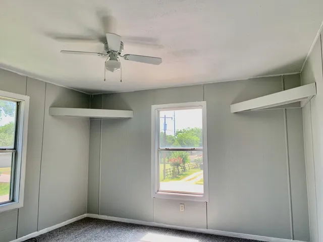 an empty room with a stove and a refrigerator