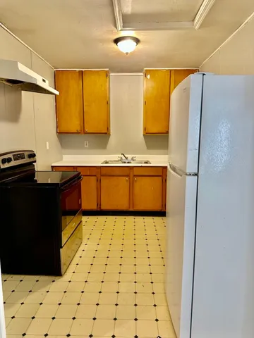 a kitchen with a sink and wooden cabinets