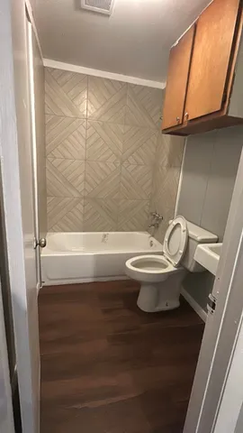 a bathroom with a toilet and a shower