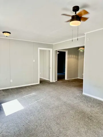 a view of an empty room with a ceiling fan