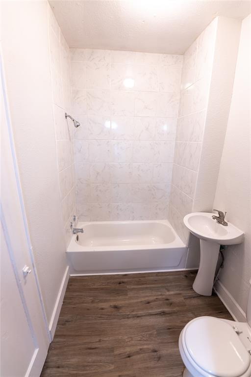 1525 Proctor Avenue Waco, TX 76708 - Photo 11 of 14 a bathroom with a sink a toilet and bathtub