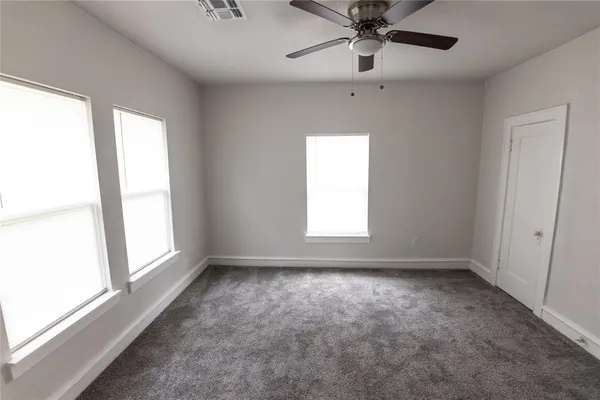 a view of room with window and ceiling fan