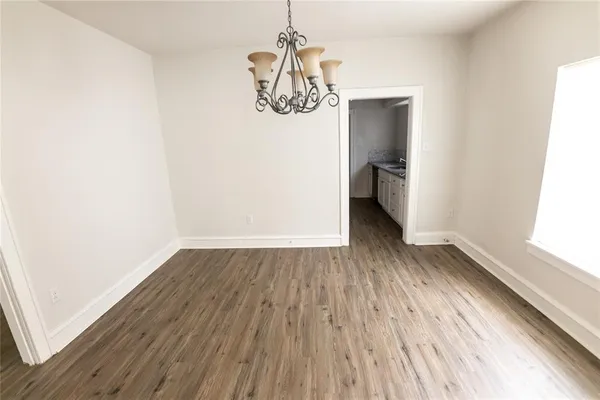 a view of a room with wooden floor