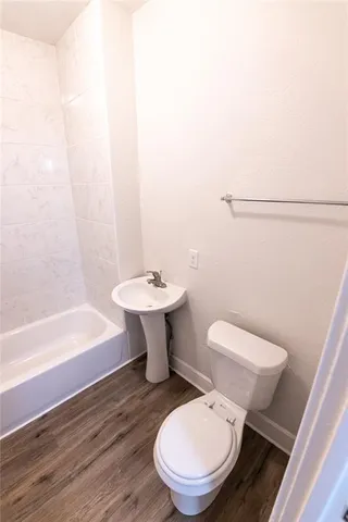 a bathroom with a sink a toilet and bathtub