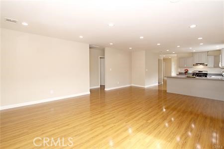1007 Del Rey Avenue Pasadena, CA 91107 - Photo 7 of 15 a view of kitchen and empty room with wooden floor
