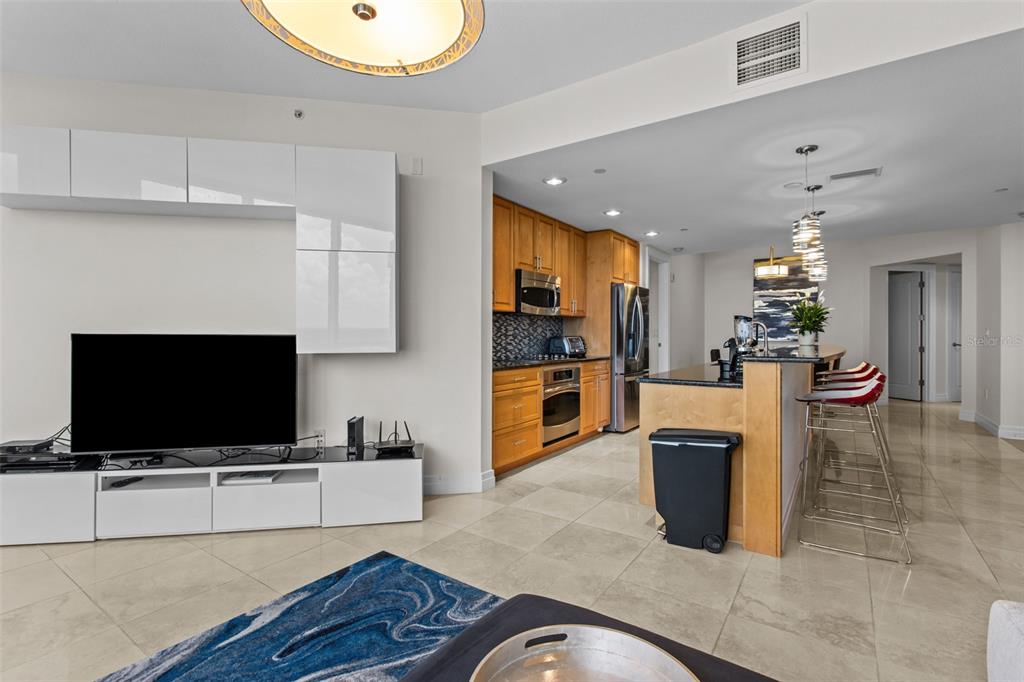 331 Cleveland Street, Unit 2102 Clearwater, FL 33755 - Photo 12 of 66 a living room with furniture and a flat screen tv
