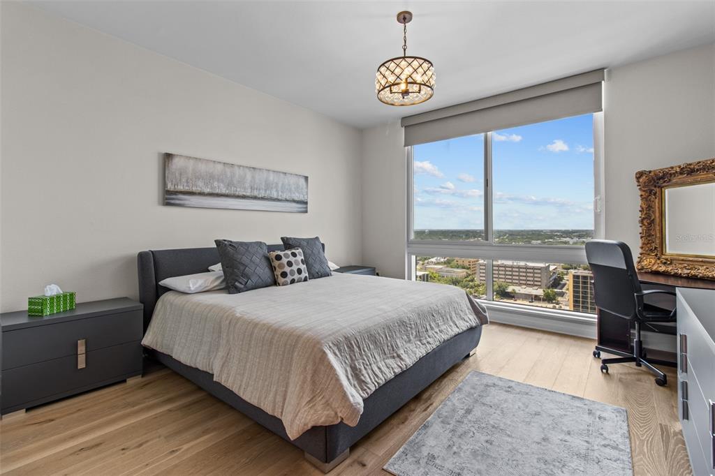 331 Cleveland Street, Unit 2102 Clearwater, FL 33755 - Photo 15 of 66 a bedroom with a bed and glass door