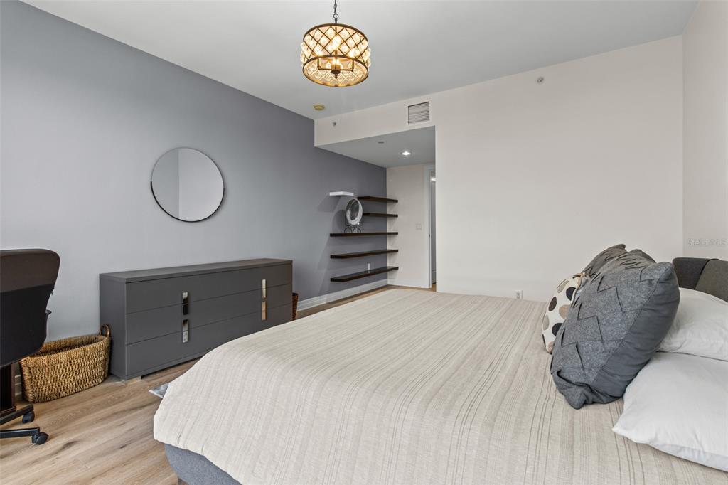 331 Cleveland Street, Unit 2102 Clearwater, FL 33755 - Photo 17 of 66 a bedroom with a bed and a chair