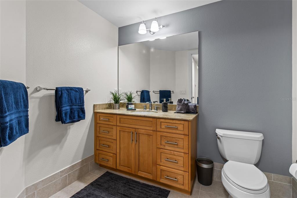 331 Cleveland Street, Unit 2102 Clearwater, FL 33755 - Photo 20 of 66 a bathroom with a toilet a sink and a mirror