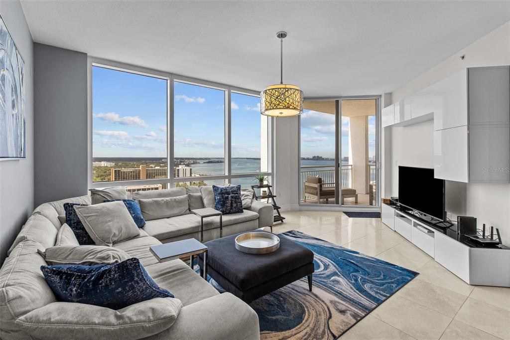 331 Cleveland Street, Unit 2102 Clearwater, FL 33755 - Photo 2 of 66 a living room with furniture and a flat screen tv