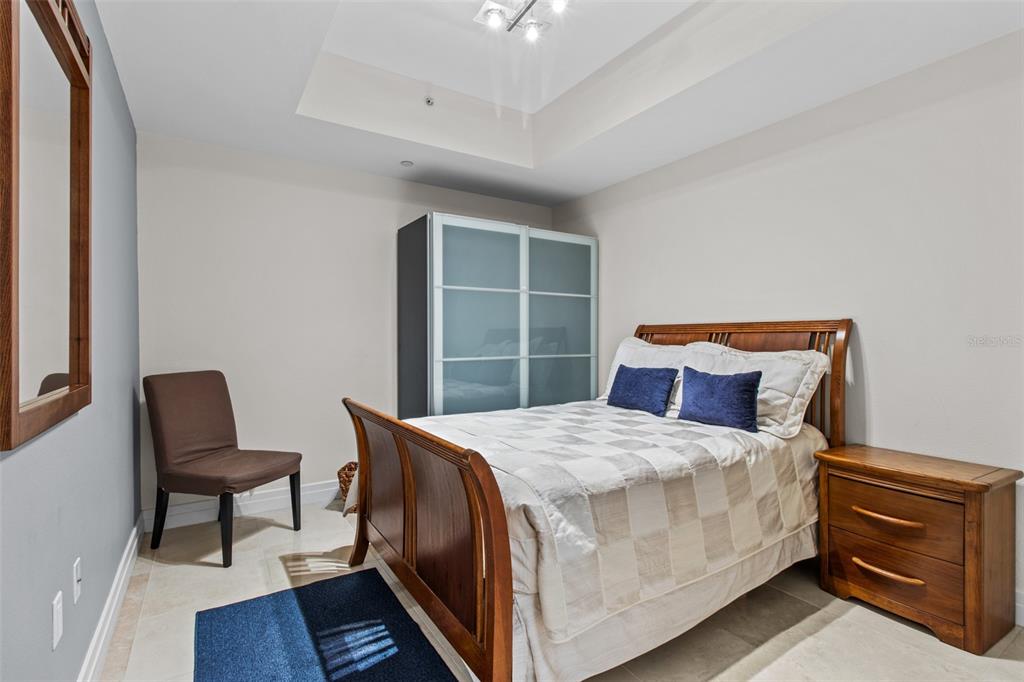 331 Cleveland Street, Unit 2102 Clearwater, FL 33755 - Photo 22 of 66 a bedroom with a bed and chair