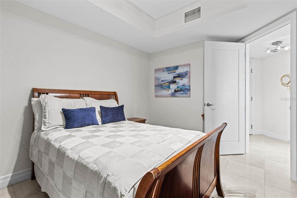 331 Cleveland Street, Unit 2102 Clearwater, FL 33755 - Photo 23 of 66 a bedroom with a bed and a painting on the wall