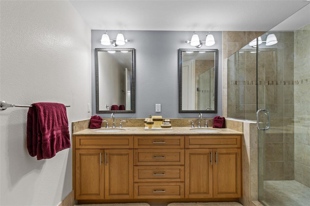 331 Cleveland Street, Unit 2102 Clearwater, FL 33755 - Photo 27 of 66 a bathroom with a double vanity sink and a mirror