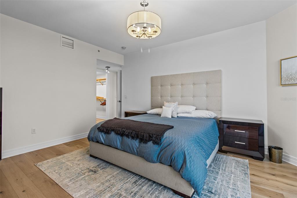 331 Cleveland Street, Unit 2102 Clearwater, FL 33755 - Photo 30 of 66 a bedroom with a bed and wooden floor