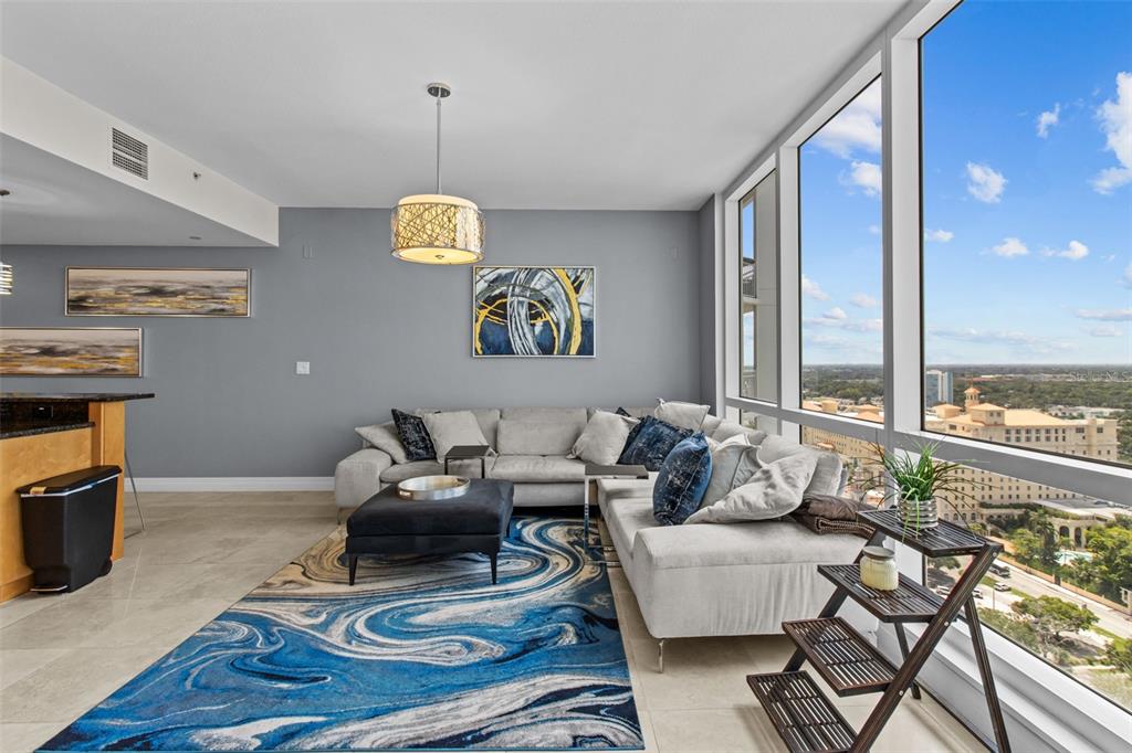 331 Cleveland Street, Unit 2102 Clearwater, FL 33755 - Photo 3 of 66 a living room with furniture and floor to ceiling windows