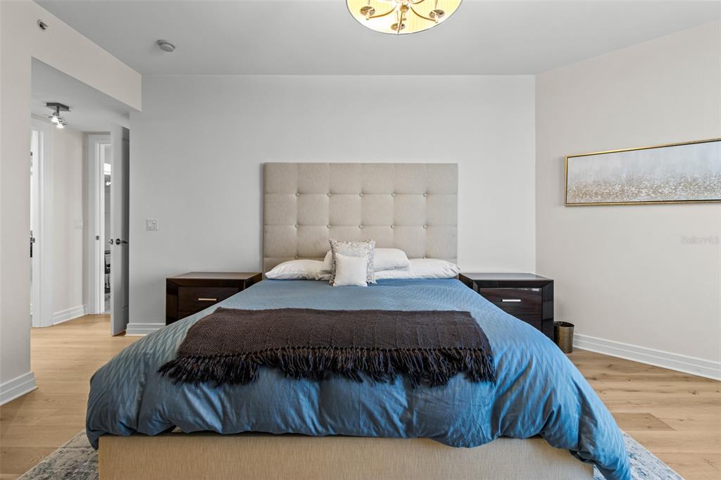 331 Cleveland Street, Unit 2102 Clearwater, FL 33755 - Photo 31 of 66 a bedroom with a bed and painting on the wall