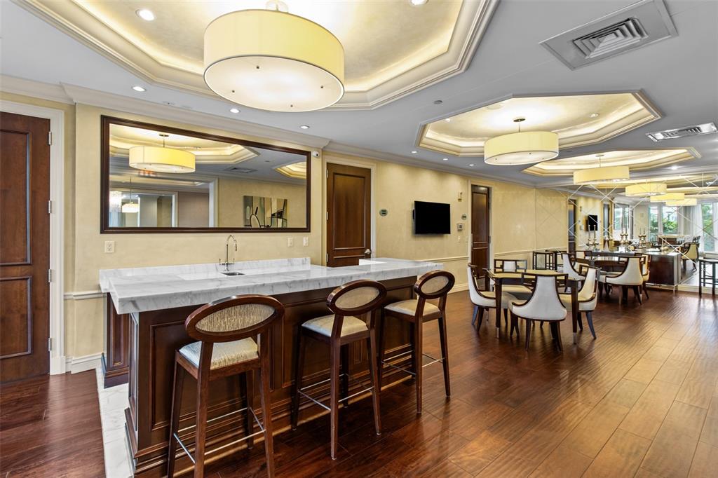 331 Cleveland Street, Unit 2102 Clearwater, FL 33755 - Photo 42 of 66 a view of a dining room with furniture and wooden floor
