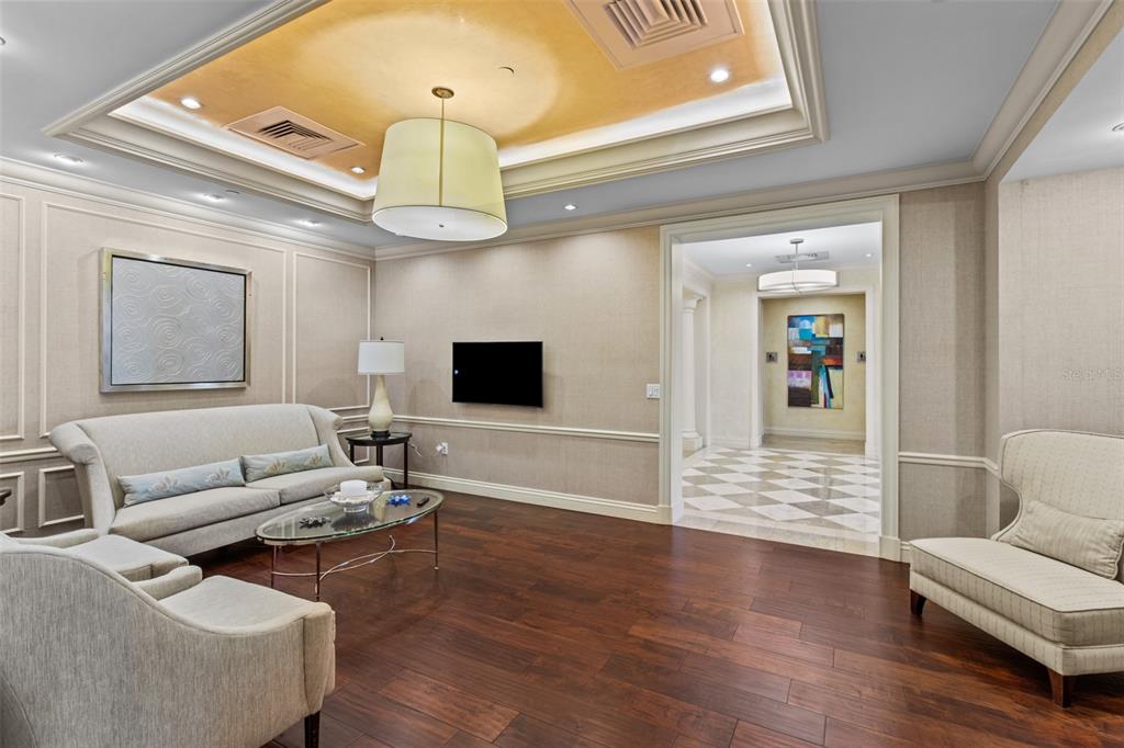 331 Cleveland Street, Unit 2102 Clearwater, FL 33755 - Photo 43 of 66 a living room with furniture and a flat screen tv